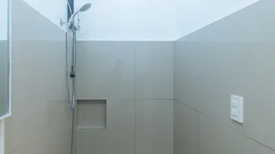 a shower with a glass door in a bathroom at Stay Manila Hotel by RedDoorz in Manila