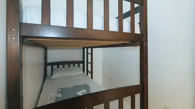 a loft bed with a bunk bed in a room at Stay Manila Hotel by RedDoorz in Manila