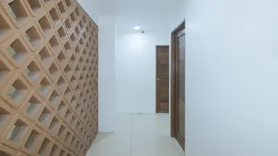 a hallway with a wooden wall and a door at Stay Manila Hotel by RedDoorz in Manila