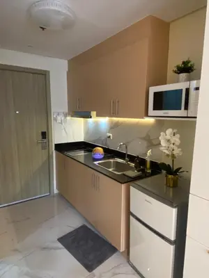 a kitchen with a sink and a microwave at Fairy Dust Sky Suite By Crib2GO in Manila