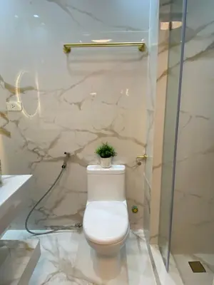 a bathroom with a toilet with a plant on it at Fairy Dust Sky Suite By Crib2GO in Manila