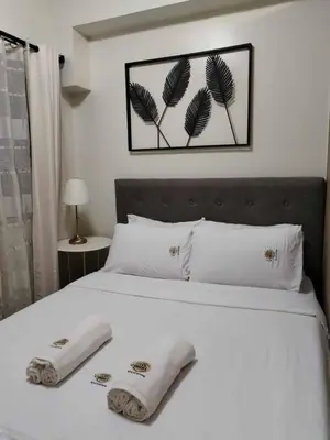 a bedroom with a bed with two towels on it at Shore Residence Tower 3 in Manila