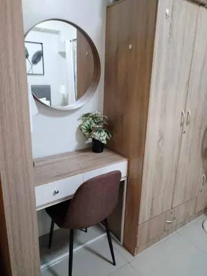 a bathroom with a desk with a mirror and a chair at Shore Residence Tower 3 in Manila