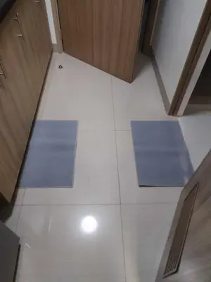two blue mats on a white floor in a room at Shore Residence Tower 3 in Manila