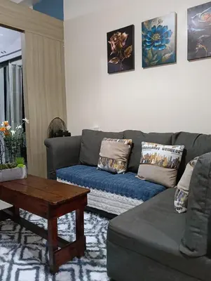 a living room with a couch and a coffee table at Shore Staycation near Moa & Airport in Manila