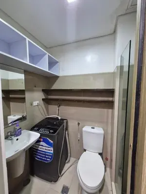 a small bathroom with a toilet and a sink at Shore Staycation near Moa & Airport in Manila