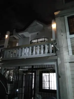 a building with a balcony with white vases on it at Affordable accommodation near NAIA, MOA and BGC in Manila