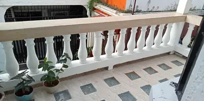 a white railing on a balcony with potted plants at Affordable accommodation near NAIA, MOA and BGC in Manila
