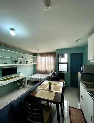 a kitchen and living room with a table and a couch at Chushers place in Santa Rosa