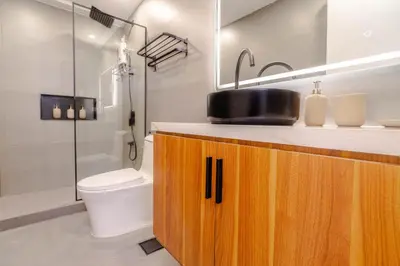 a bathroom with a sink and a toilet and a shower at Éire Home Stay in Manila