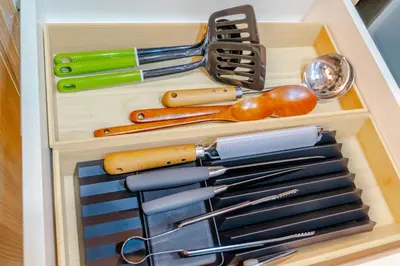 a drawer filled with knives and utensils at Éire Home Stay in Manila