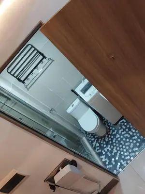 a reflection of a bathroom with a sink and a mirror at Fully Furnished 1 Bedroom Condo - Fame Residences, Tower 2 in Manila