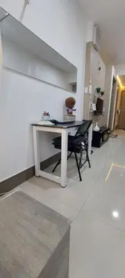 a white table in a living room with a chair at Fully Furnished 1 Bedroom Condo - Fame Residences, Tower 2 in Manila