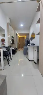 a large living room with a table and a couch at Fully Furnished 1 Bedroom Condo - Fame Residences, Tower 2 in Manila