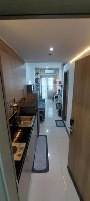 a kitchen with a counter and a living room at Fully Furnished 1 Bedroom Condo - Fame Residences, Tower 2 in Manila