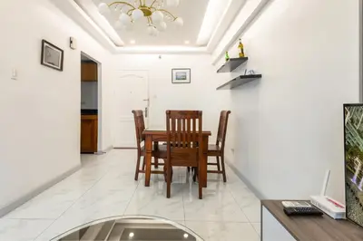 a dining room with a table and chairs at Forbeswood Heights BGC suite near st Lukes in Manila