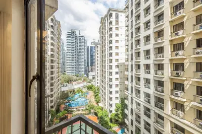 a view from a window of a city with tall buildings at Forbeswood Heights BGC suite near st Lukes in Manila