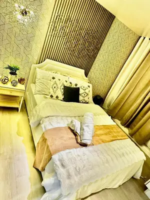 a bedroom with two beds and a chandelier at AZURE BICUTAN -MIAMI TOWER 6 Floor in Manila