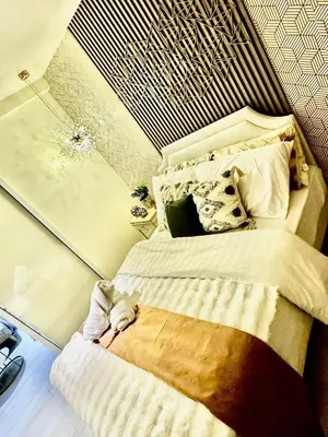 a bedroom with a large bed with aigunigunigun at AZURE BICUTAN -MIAMI TOWER 6 Floor in Manila