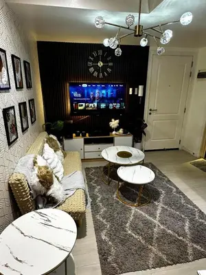 a living room with two cats sitting on a couch at AZURE BICUTAN -MIAMI TOWER 6 Floor in Manila