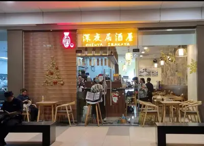 a restaurant with people sitting at tables in front of it at Modern Double-Sized Bed with Netflix & Pool View in Manila