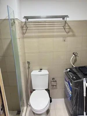 a small bathroom with a toilet and a shower at Modern Double-Sized Bed with Netflix & Pool View in Manila