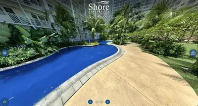 a swimming pool in front of a building at Modern Double-Sized Bed with Netflix & Pool View in Manila