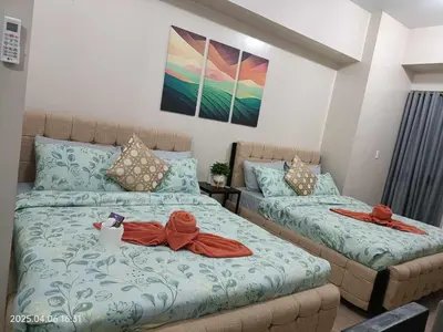 a bedroom with two beds with towels on them at 81 Newport Boulevard across Manila Airport NAIA T3 in Manila