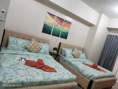 a bedroom with two beds with red bows on them at 81 Newport Boulevard across Manila Airport NAIA T3 in Manila