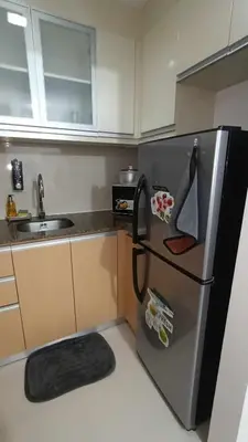 a kitchen with a refrigerator with magnets on it at 81 Newport Boulevard across Manila Airport NAIA T3 in Manila