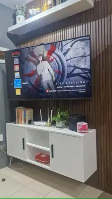 a white entertainment center with a poster on a wall at 1BR with Prime Netflix, Disney HBO max in Manila