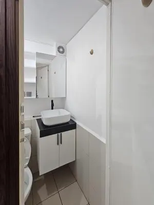 a white bathroom with a sink and a toilet at 1BR with Prime Netflix, Disney HBO max in Manila