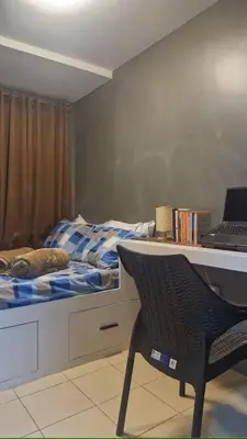 a bedroom with a bed and a desk with a laptop at 1BR with Prime Netflix, Disney HBO max in Manila