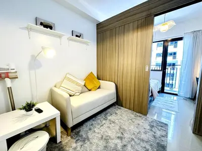 a living room with a couch and a table at FT1161 House in Manila