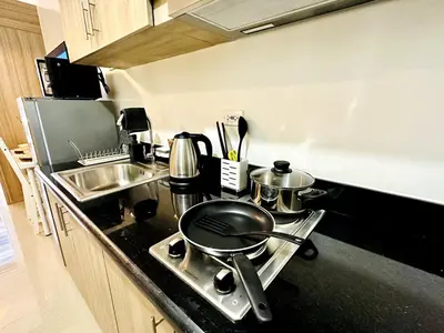 a kitchen with a stove with pots and pans on it at FT1161 House in Manila