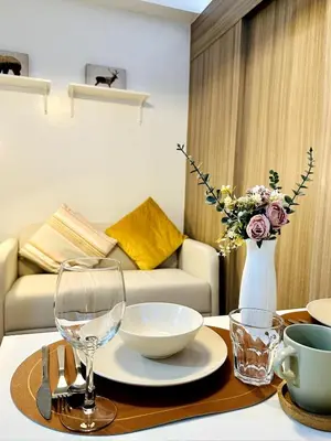 a living room with a table with glasses and a couch at FT1161 House in Manila