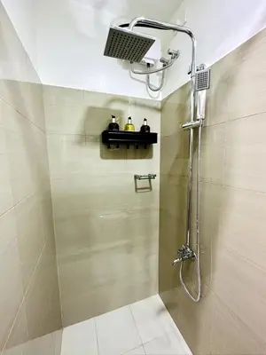 a bathroom with a shower with a shower head at FT1161 House in Manila