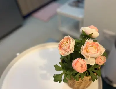 a bouquet of pink roses in a vase on a table at JR864 House in Manila