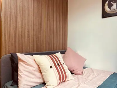 a pile of pillows sitting on top of a bed at JR864 House in Manila