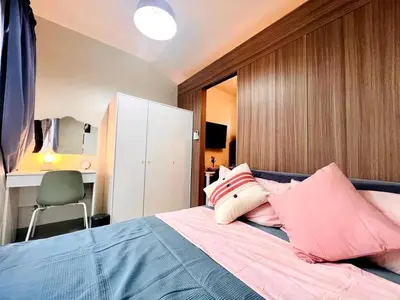 a bedroom with a bed with pink pillows at JR864 House in Manila