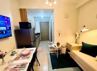 a small living room with a couch and a table at JR864 House in Manila