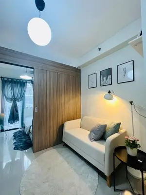 a living room with a couch and a table at TM1410 House in Manila