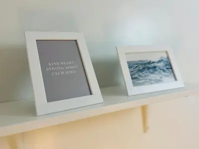 two framed photographs sitting on a shelf at TM1410 House in Manila