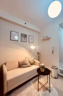 a living room with a couch and a table at TM1410 House in Manila