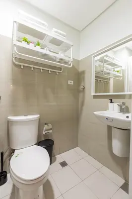 a bathroom with a toilet and a sink at SB1054 House in Manila