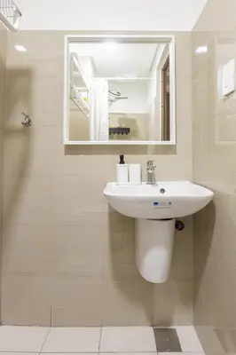 a bathroom with a sink and a mirror at SB1054 House in Manila