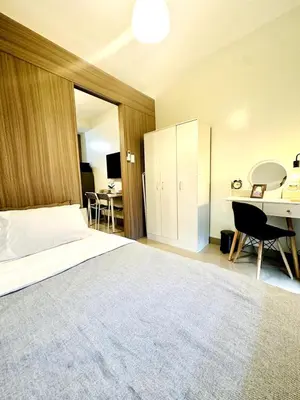 a hotel room with a bed and a desk and a desk at OREO1232 House in Manila