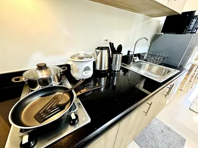 a kitchen with two pots and pans on a stove at OREO1232 House in Manila