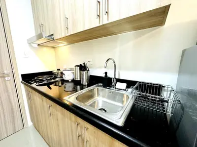 a kitchen with a sink and a black counter top at OREO1232 House in Manila