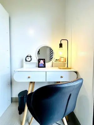 a desk with a black chair and a mirror at OREO1232 House in Manila